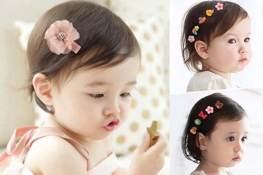 Bé gái 1 tuổi tóc ngắn được trang trí với kẹp nơ nhiều màu sắc