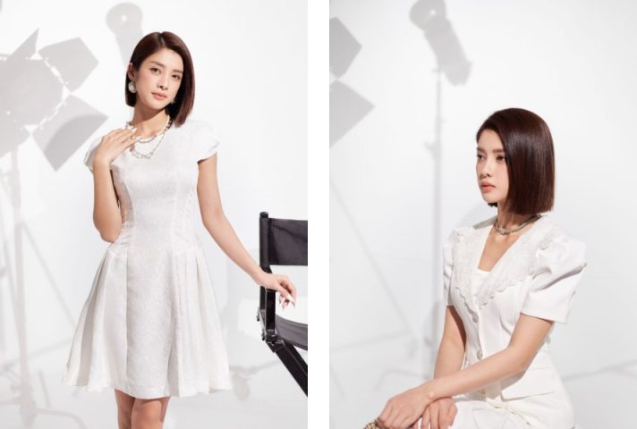 Cô gái tóc ngắn duyên dáng trong áo sơ mi kiểu và chân váy ngắn màu pastel