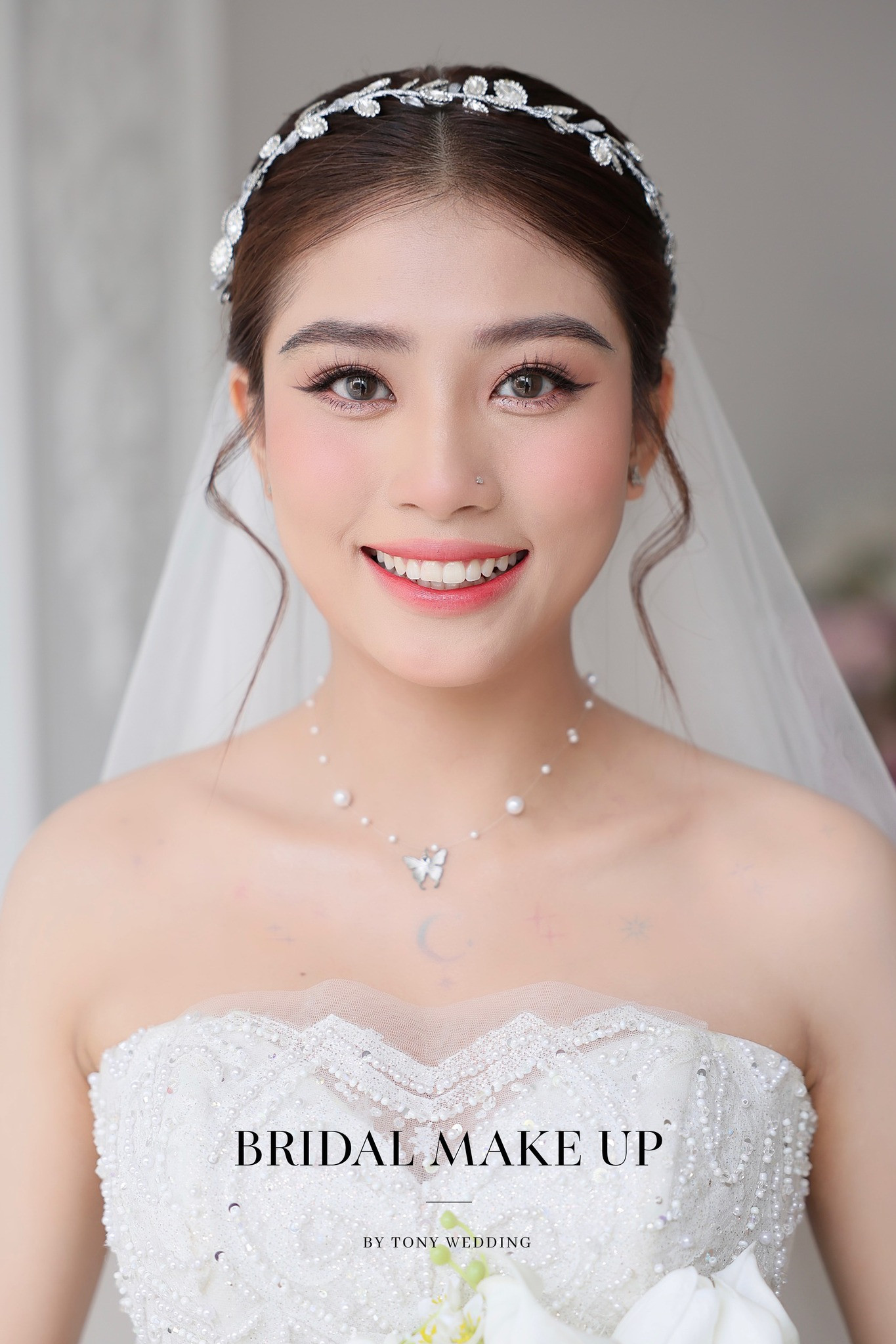 Gương mặt rạng rỡ của cô dâu với kiểu tóc búi cao trẻ trung, phù hợp mùa hè