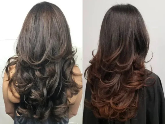 Mái tóc dài uốn lọn to bồng bềnh, che đi vùng má hóp và làm gương mặt gầy mềm mại hơn