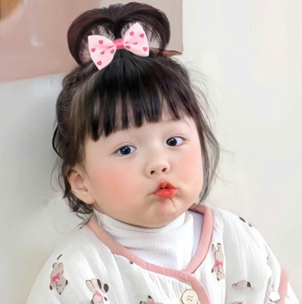 Bé gái với kiểu tết tóc ngắn chỏm đỉnh đầu tinh nghịch