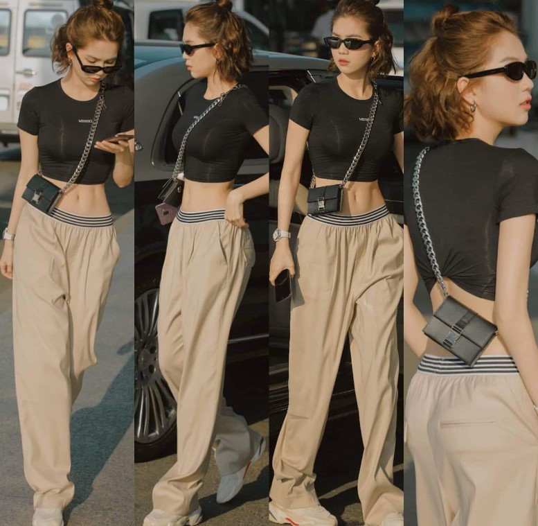 Cô gái tóc ngắn diện áo croptop màu be và quần ống rộng, toát lên vẻ thanh lịch