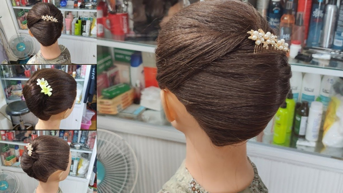 Kiểu tóc búi nửa đầu kết hợp hoa cài cho bà sui, giúp mẹ chồng thêm phần nổi bật và thanh lịch.