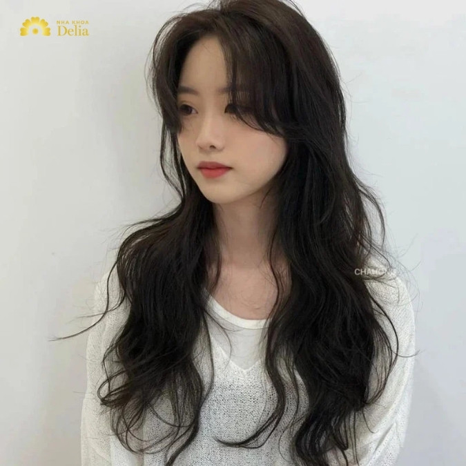 Kiểu tóc xoăn layer nhẹ nhàng, ôm gọn gương mặt, là lựa chọn tinh tế trong các kiểu tóc nữ năm 2024.